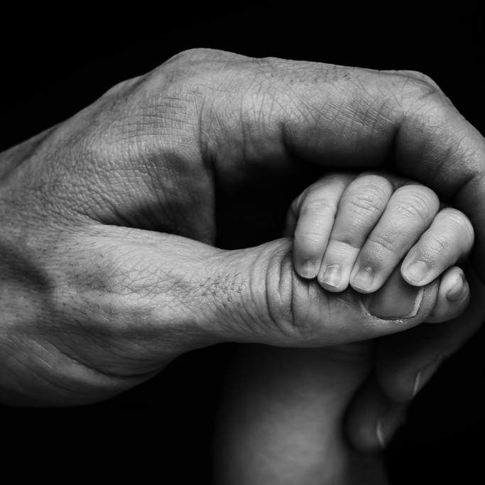 Baby and father hand