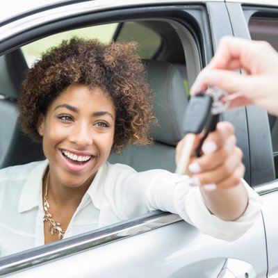 Young woman receiving car keys